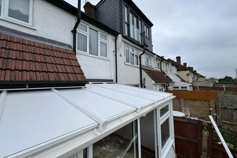 New white insulated panel lean-to roof at the back of a terraced house