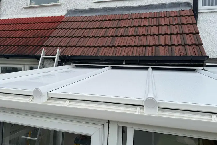 Close view of white roof panels and glazing bar caps on a finished lean-to conservatory