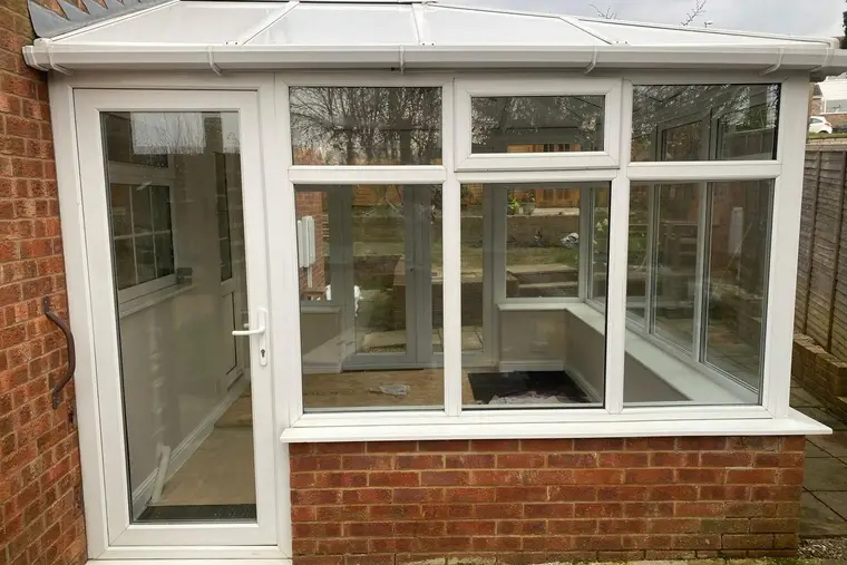 Front of a white conservatory after its new insulated panel roof was fitted