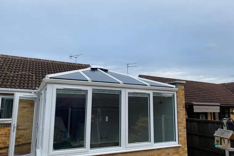 Victorian conservatory finished with an anthracite grey insulated panel roof