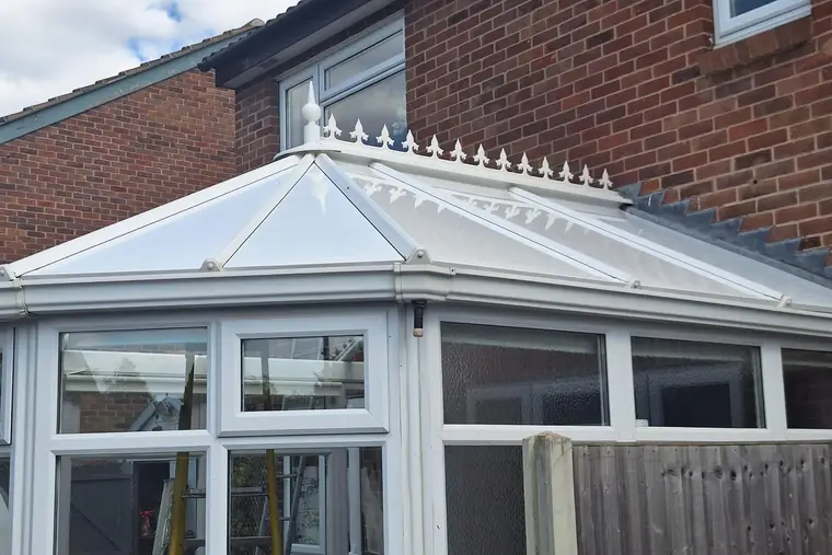 White insulated panel roof with ridge cresting on a Victorian conservatory
