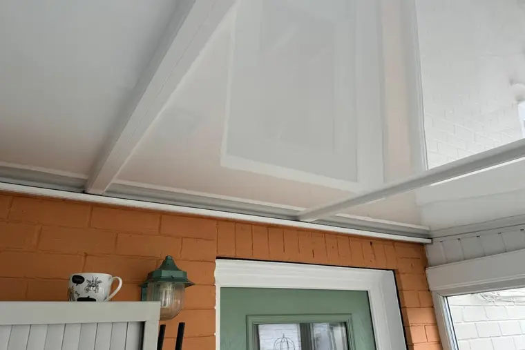 Lean-to panel ceiling finished neatly above the back door of the house